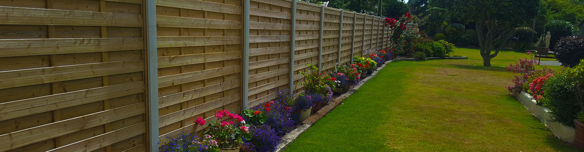 Guernsey garden fencing header photo of a beautiful wooden fence with concrete posts.