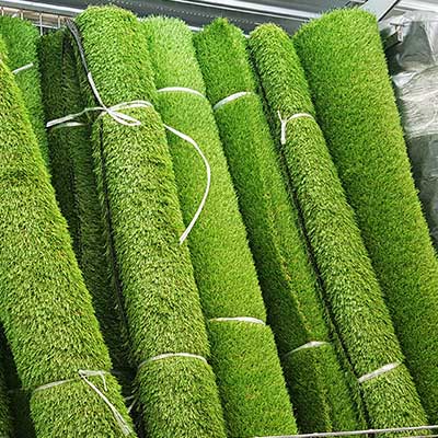 A line of rolled up artificial grass we supply.